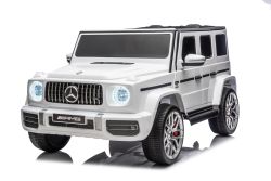Elektrische kinderauto Mercedes-Benz G63 AMG 4x4, tweezits, 24V, wit, MP3-speler met USB/AUX- en Bluetooth-verbinding, 4x4-aandrijving, lithiumbatterij, EVA-wielen met vering, stoelen van kunstleer, afstandsbediening, officieel gelicentieerd